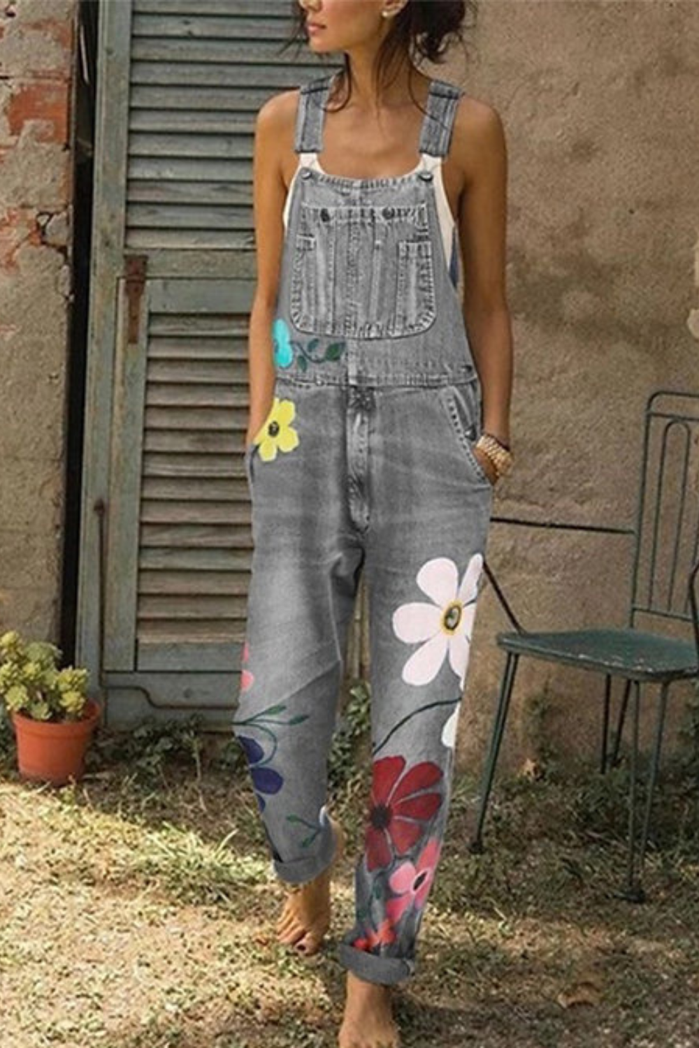 Ärmelloser Denim-Overall mit Blumenmuster, verstellbaren Trägern und Taschen, lässig geschnitten für vielseitigen Stil.