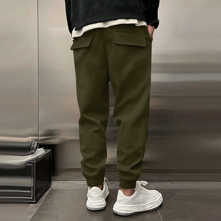 Atmungsaktive Sporthose für Herren, dunkelgrau, mit elastischem Bund, modernes Design, ideal für Sport und Freizeit.