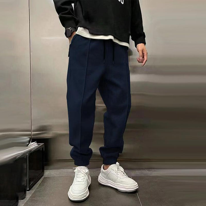 Atmungsaktive Sporthose für Herren, dunkelgrau, mit elastischem Bund, modernes Design, ideal für Sport und Freizeit.