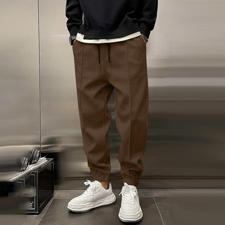 Atmungsaktive Sporthose für Herren, dunkelgrau, mit elastischem Bund, modernes Design, ideal für Sport und Freizeit.