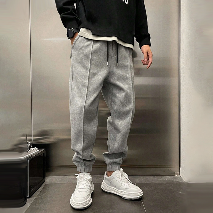 Atmungsaktive Sporthose für Herren, dunkelgrau, mit elastischem Bund, modernes Design, ideal für Sport und Freizeit.