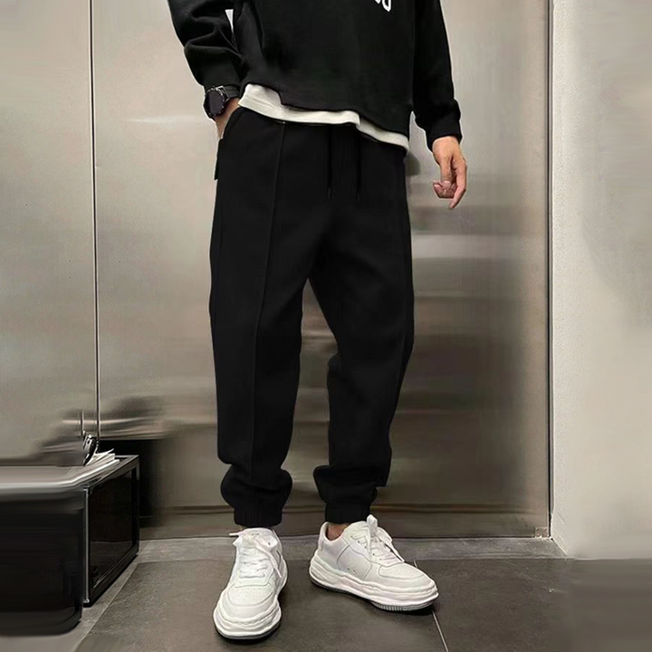 Atmungsaktive Sporthose für Herren, dunkelgrau, mit elastischem Bund, modernes Design, ideal für Sport und Freizeit.