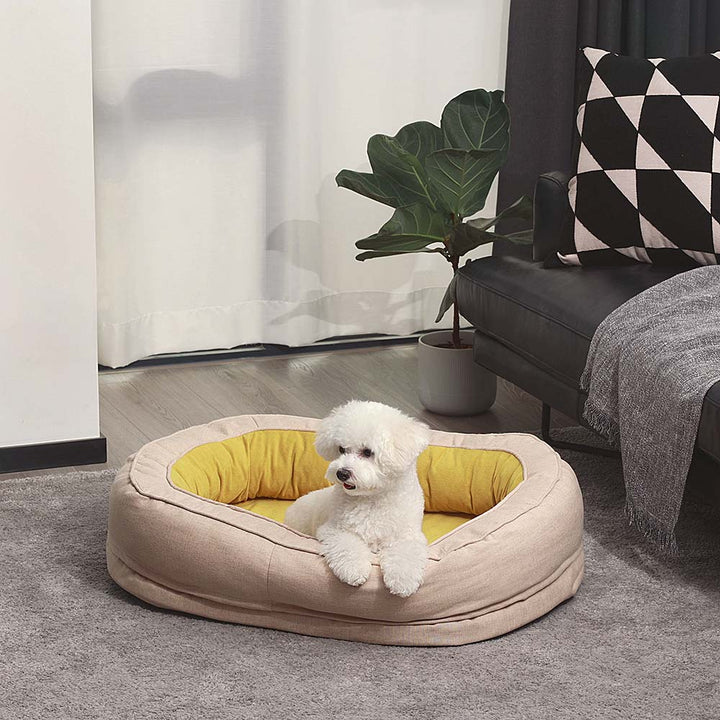 Braunes orthopädisches Hundebett im flauschigen Donut-Design, bietet Komfort und Gelenkschutz.