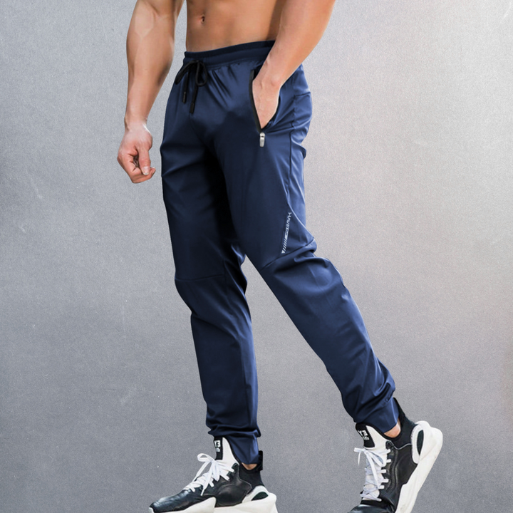 Elastische Herren Sporthose, atmungsaktiv mit Reißverschluss, ideal für Sport und Alltag, in modernem Design.
