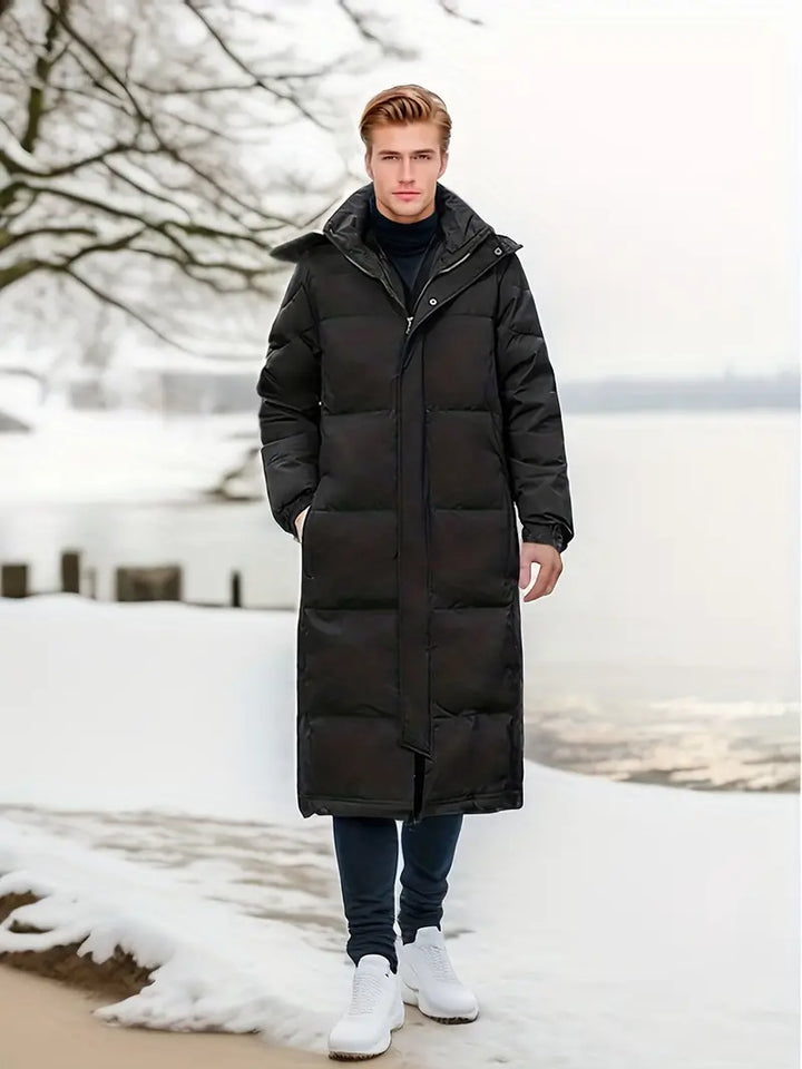 Elegante lange Herren-Winter-Steppjacke mit gestepptem Design und optimiertem Wetterschutz für kühle Tage.