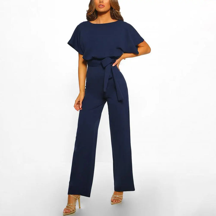 "Eleganter Damen Jumpsuit in Beige, Schwarz und Pink, mit Gürtel und fließender Silhouette, ideal für Sommer."