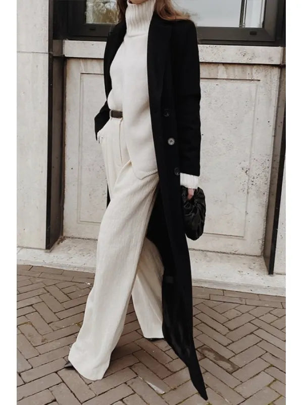 "Eleganter schwarzer Wintermantel, langärmelig mit Taschen, ideal für kühle Tage und formelle Anlässe."