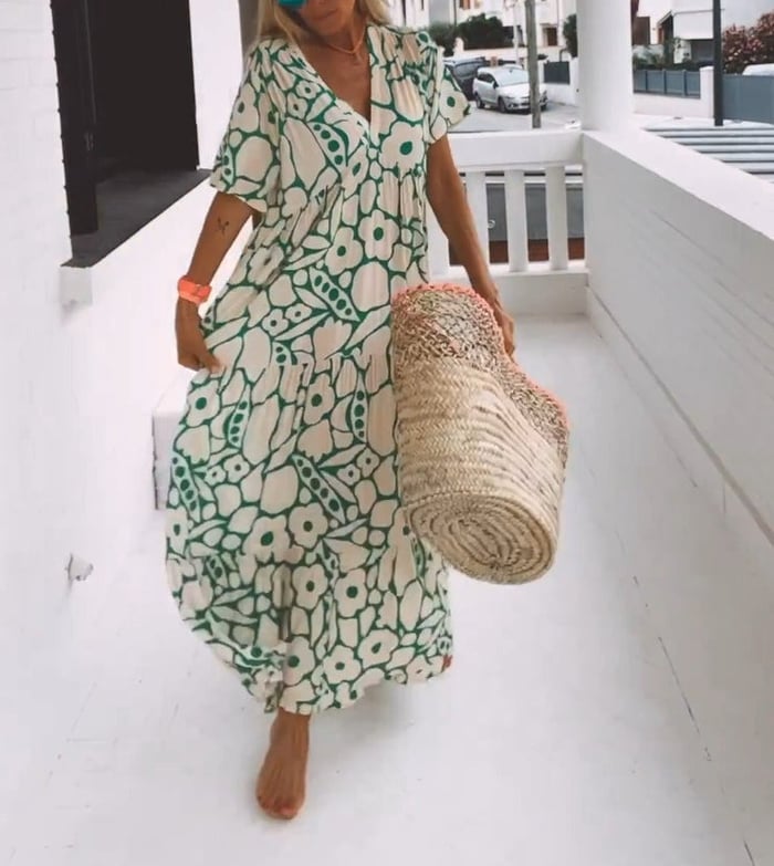 Elegantes Blumenkleid für Damen mit lebendigem Blumenmuster und fließender Silhouette, ideal für sommerliche Anlässe.