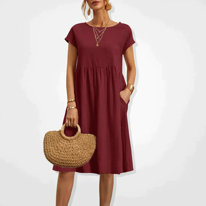 "Elegantes Damen-Sommerkleid mit Empire-Silhouette, kurze Ärmel, luftiger Rock, ideal für warme Tage, vielseitiger Stil."