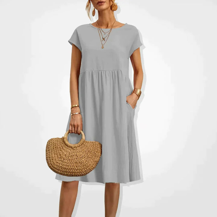 "Elegantes Damen-Sommerkleid mit Empire-Silhouette, kurze Ärmel, luftiger Rock, ideal für warme Tage, vielseitiger Stil."