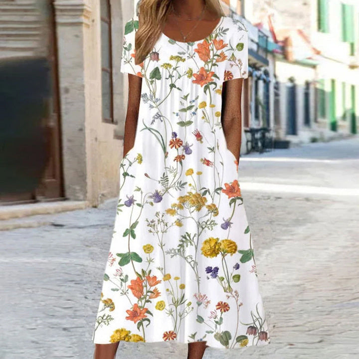 Elegantes Damenkleid mit lebendigem Blumenmuster und schmeichelhaftem Schnitt, ideal für formelle oder lässige Anlässe.