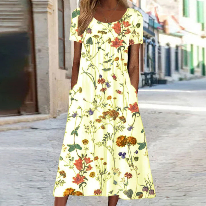Elegantes Damenkleid mit lebendigem Blumenmuster und schmeichelhaftem Schnitt, ideal für formelle oder lässige Anlässe.