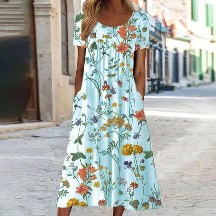 Elegantes Damenkleid mit lebendigem Blumenmuster und schmeichelhaftem Schnitt, ideal für formelle oder lässige Anlässe.
