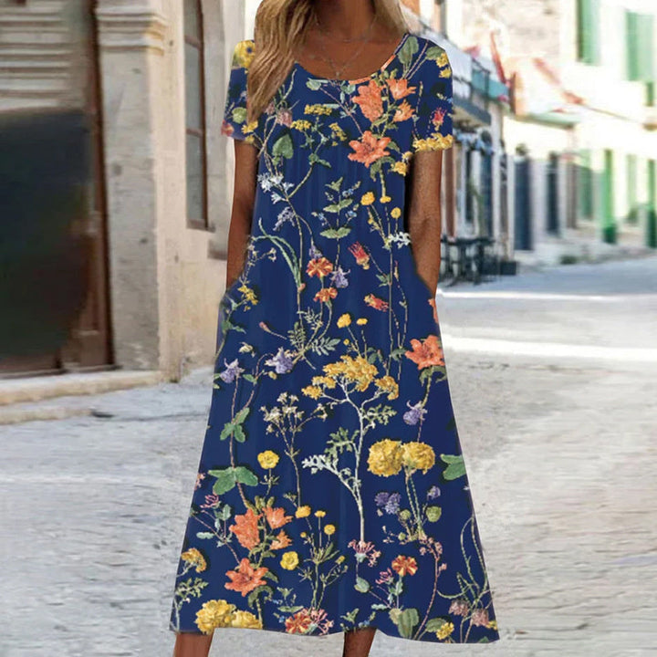 Elegantes Damenkleid mit lebendigem Blumenmuster und schmeichelhaftem Schnitt, ideal für formelle oder lässige Anlässe.