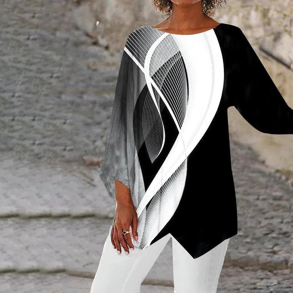 Geometrisches Langarm-Damentop in Schwarz-Weiß, asymmetrischer Saum, vielseitig kombinierbar für elegante und modische Looks.