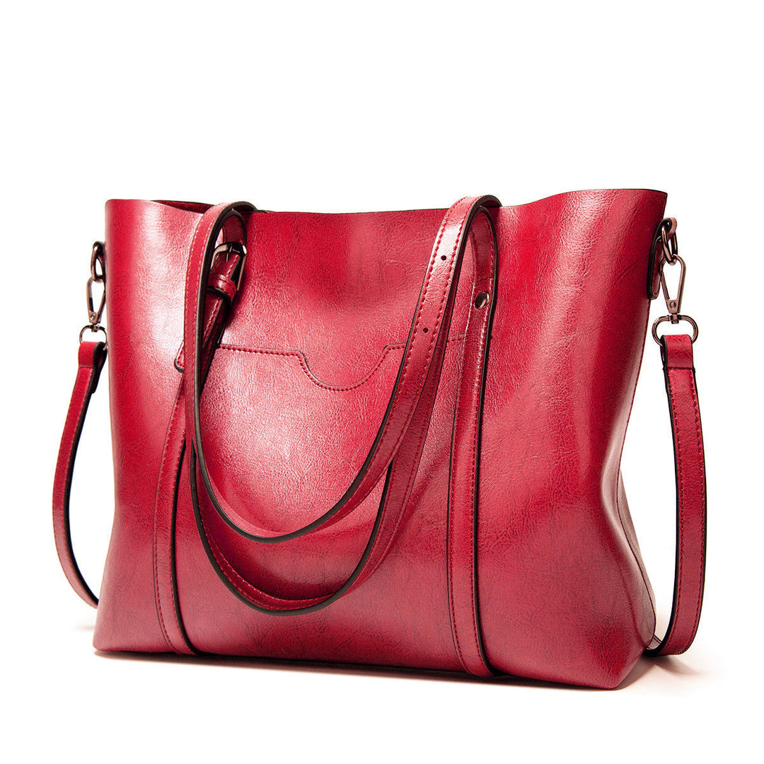 "Handgefertigte Lederhandtasche für Damen in elegantem Design mit verstärkten Griffen und geräumigem Innenraum."