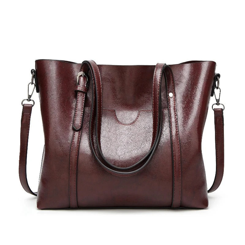 "Handgefertigte Lederhandtasche für Damen in elegantem Design mit verstärkten Griffen und geräumigem Innenraum."
