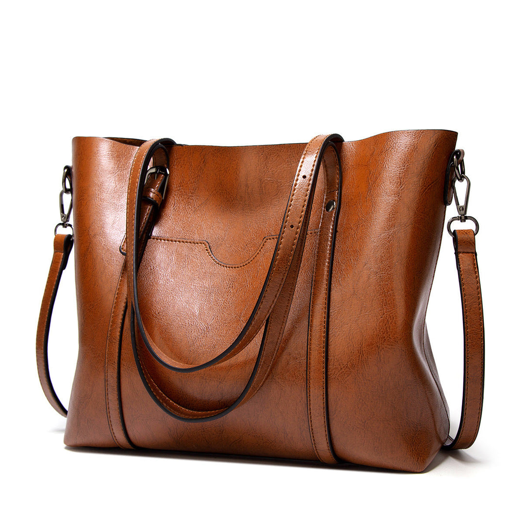 "Handgefertigte Lederhandtasche für Damen in elegantem Design mit verstärkten Griffen und geräumigem Innenraum."