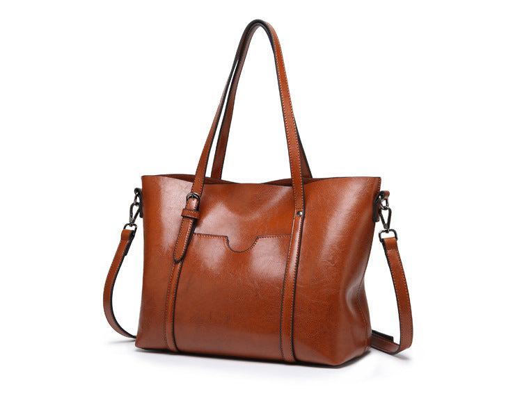 "Handgefertigte Lederhandtasche für Damen in elegantem Design mit verstärkten Griffen und geräumigem Innenraum."