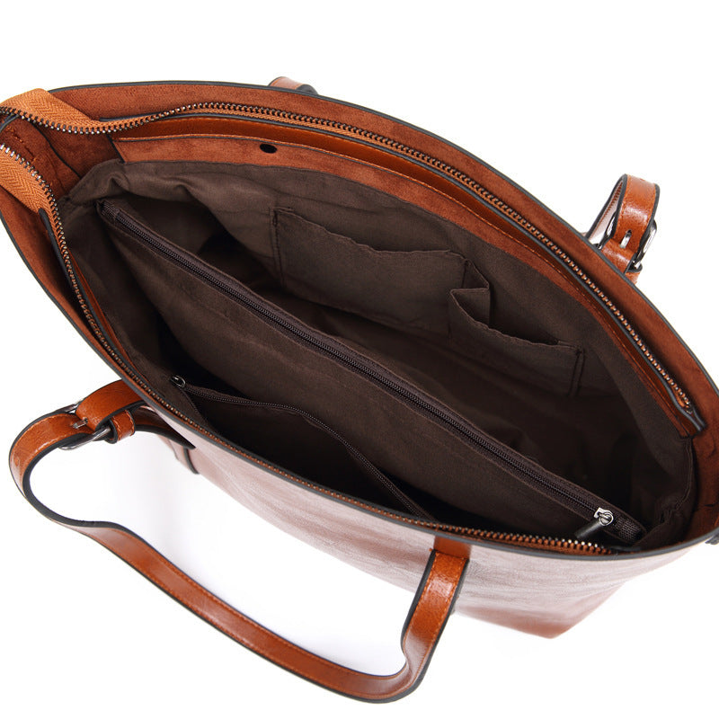 "Handgefertigte Lederhandtasche für Damen in elegantem Design mit verstärkten Griffen und geräumigem Innenraum."