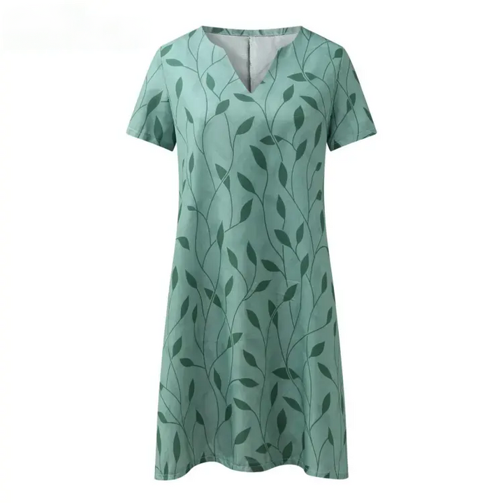 Kurzärmeliges Frauenkleid mit Blattmuster, luftiges Sommer-Mini in Grün und Weiß, ideal für warme Tage und Abende.
