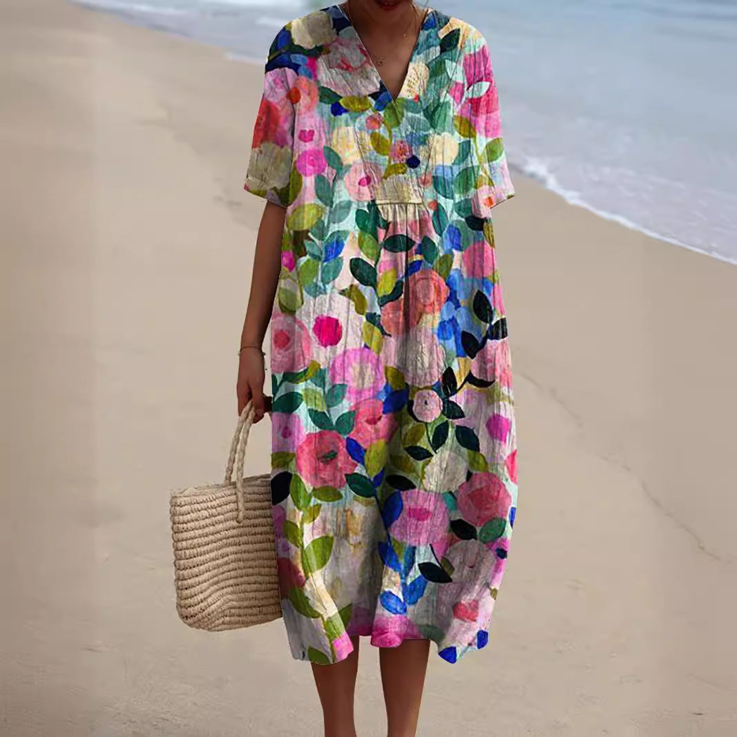"Lebhaftes Sommerkleid mit V-Ausschnitt und Blumenmuster, ideal für sonnige Tage; locker geschnitten und aus Baumwolle."