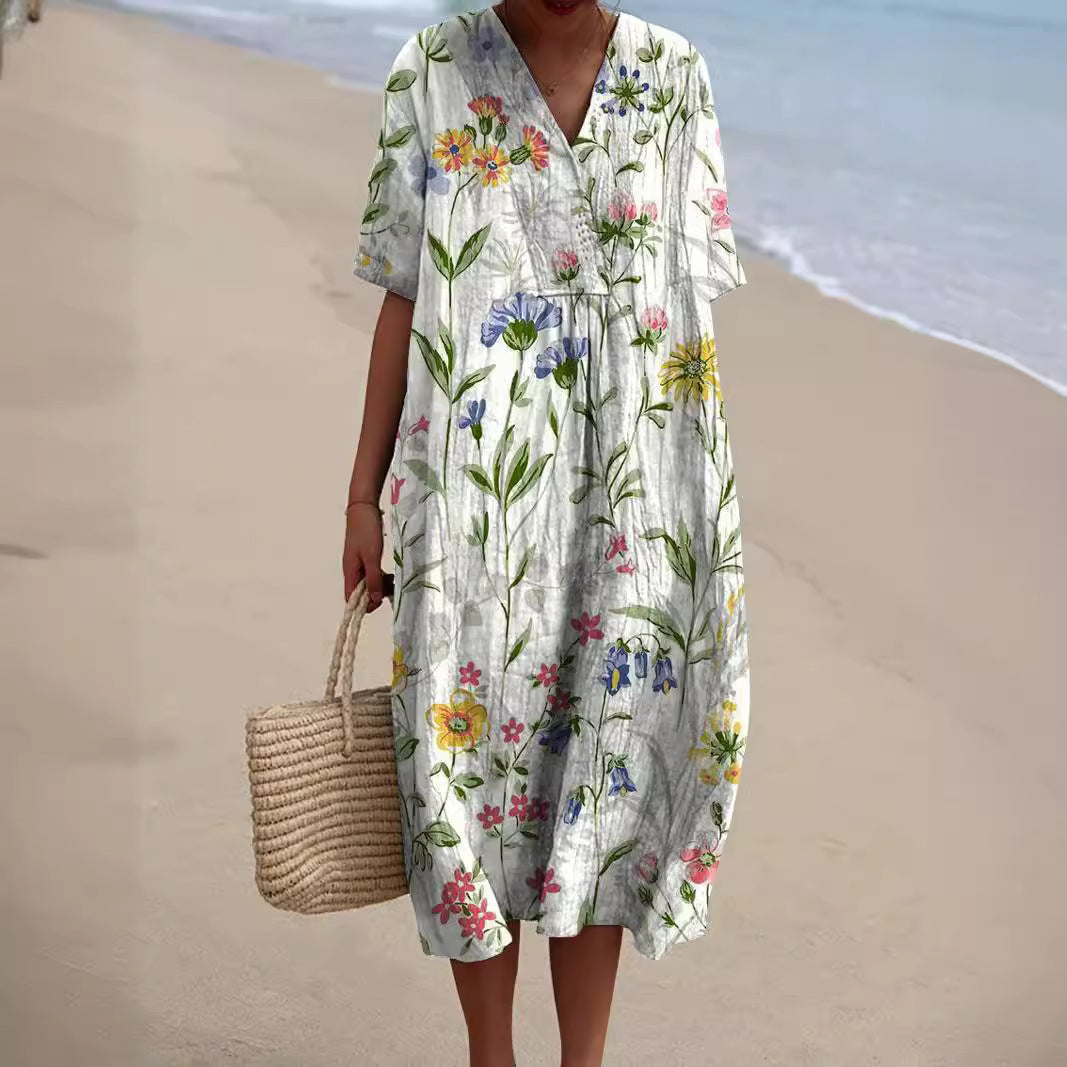 "Lebhaftes Sommerkleid mit V-Ausschnitt und Blumenmuster, ideal für sonnige Tage; locker geschnitten und aus Baumwolle."