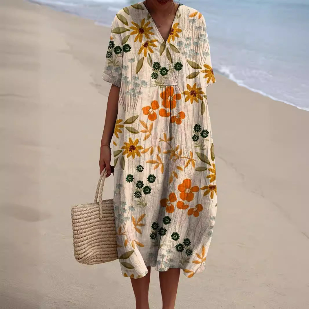 "Lebhaftes Sommerkleid mit V-Ausschnitt und Blumenmuster, ideal für sonnige Tage; locker geschnitten und aus Baumwolle."