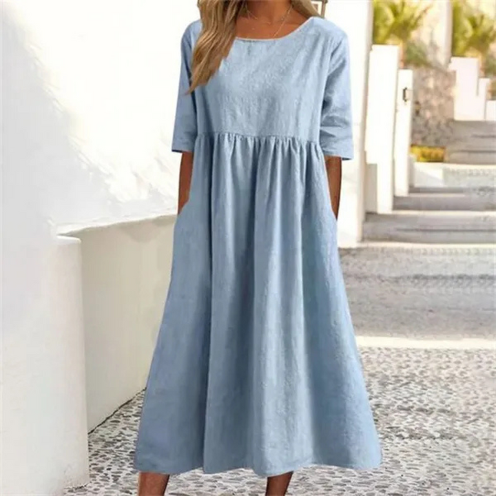 Leichtes Midi-Sommerkleid Damen, luftig und komfortabel, in hellem Farbton, mit lockerer Passform und Seitentaschen.