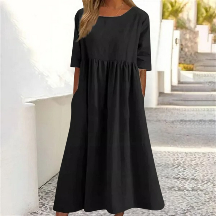 Leichtes Midi-Sommerkleid Damen, luftig und komfortabel, in hellem Farbton, mit lockerer Passform und Seitentaschen.