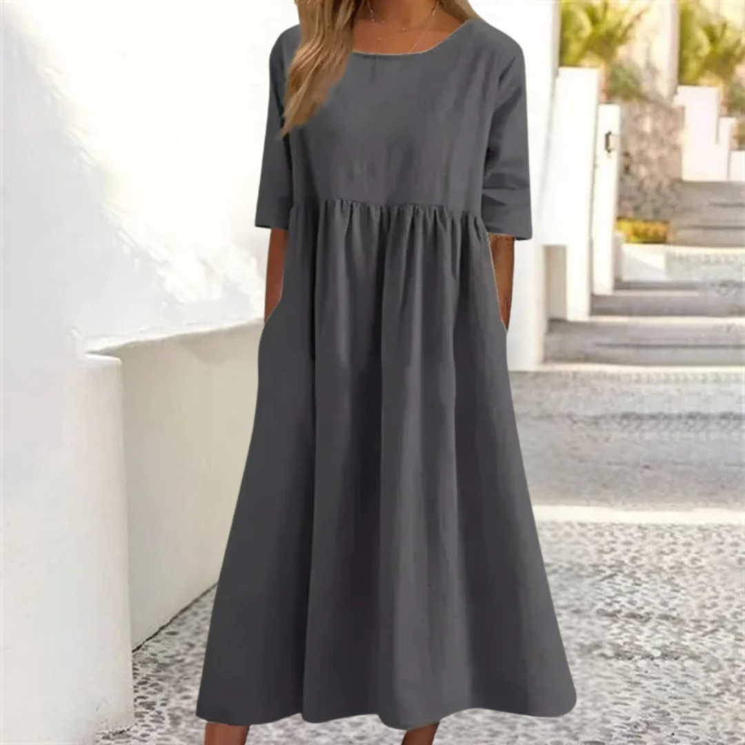 Leichtes Midi-Sommerkleid Damen, luftig und komfortabel, in hellem Farbton, mit lockerer Passform und Seitentaschen.