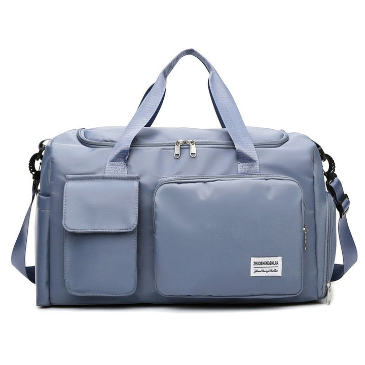 "Lila Damen-Reisetasche mit Schuhfach und mehreren Taschen, ideal für Reisen und Sport, robust und wasserdicht."