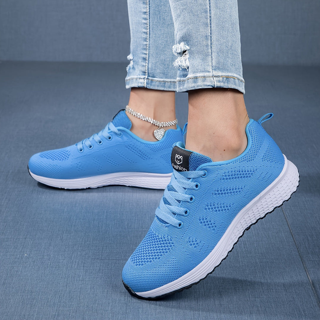 "Moderne atmungsaktive Damen-Sneaker, ideal für Freizeit und Sport, mit sicherem Schnürverschluss in Weißgrau."