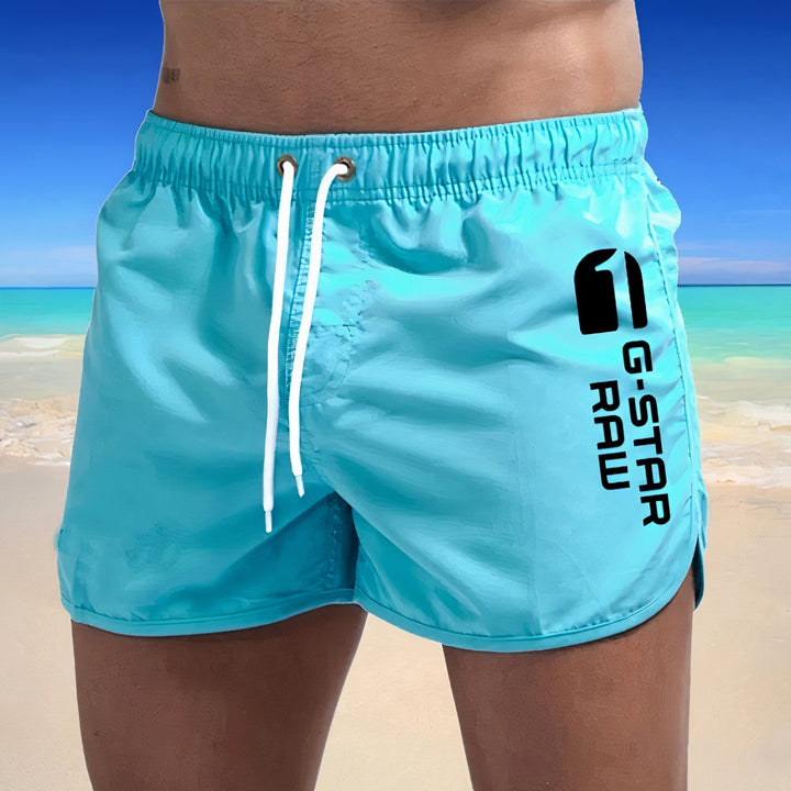 "Schnelltrocknende blaue Herren Badehose, stilvolles Design, elastischer Bund, ideal für Strand und Pool."