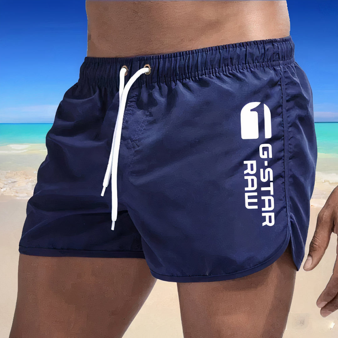 "Schnelltrocknende blaue Herren Badehose, stilvolles Design, elastischer Bund, ideal für Strand und Pool."